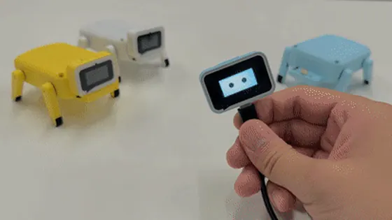Animated demo of three ESP-Hi open-source AI robot dogs in blue, yellow and white walking on a table