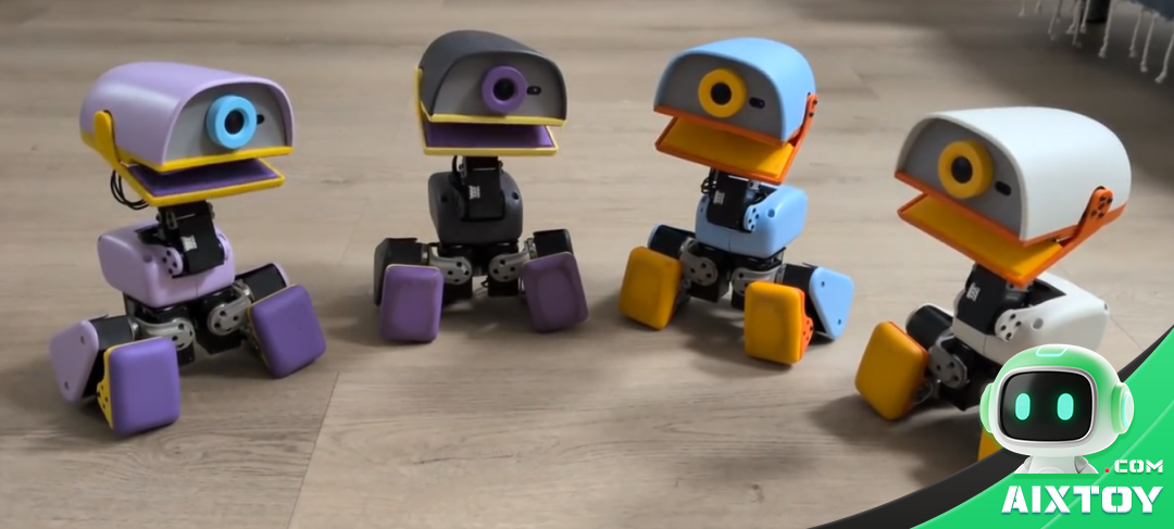 Four Microduck duck robots standing on a wooden floor in a home setting