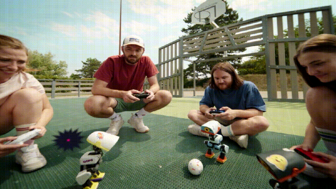 Animated Microduck robots playing soccer controlled by players with gamepads