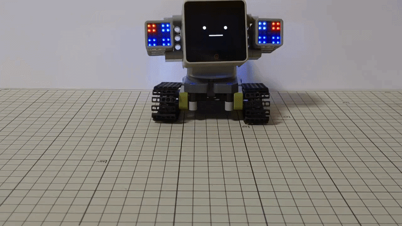 StackChan ESP32-S3 desktop robot turning its head and changing expression on the touch screen