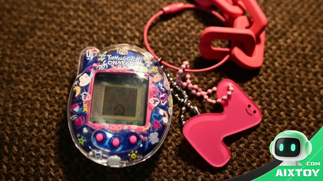 Tamagotchi digital pet device with stickers and charms on a carpet