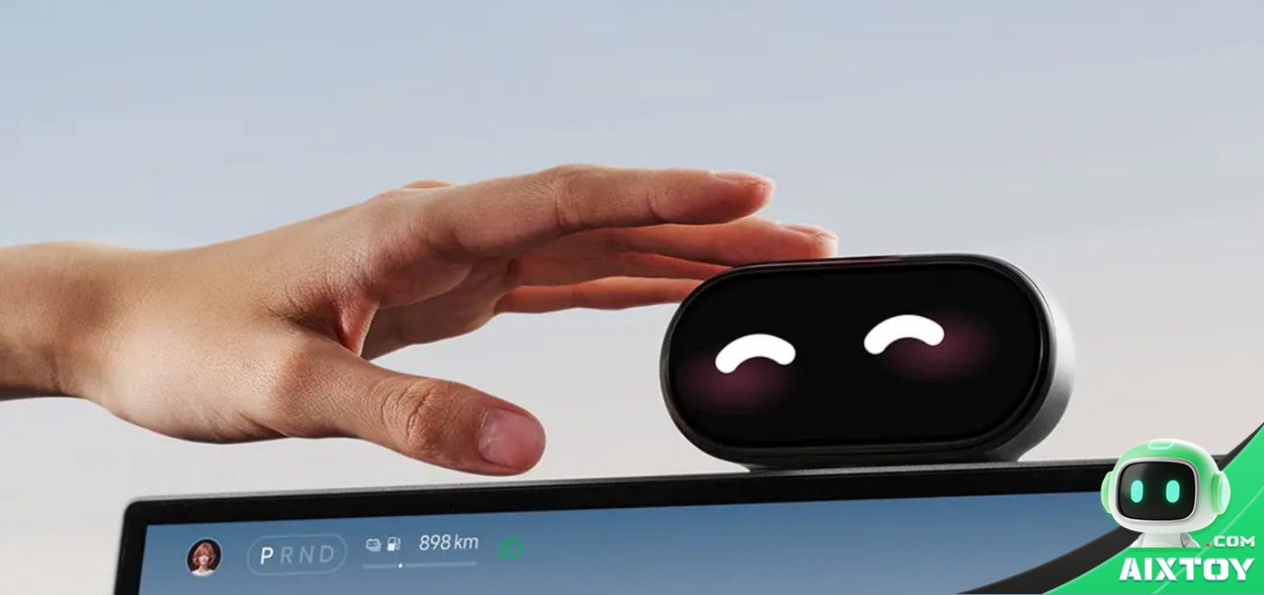 A hand touching the top of the Xiaomi Smart Dial 2 mounted above a car centre screen, with the dial showing a happy squinting face